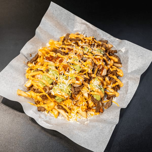 El Burrito Taco Shop's carne asada fries, topped with cheese, guacamole, and a creamy sauce.